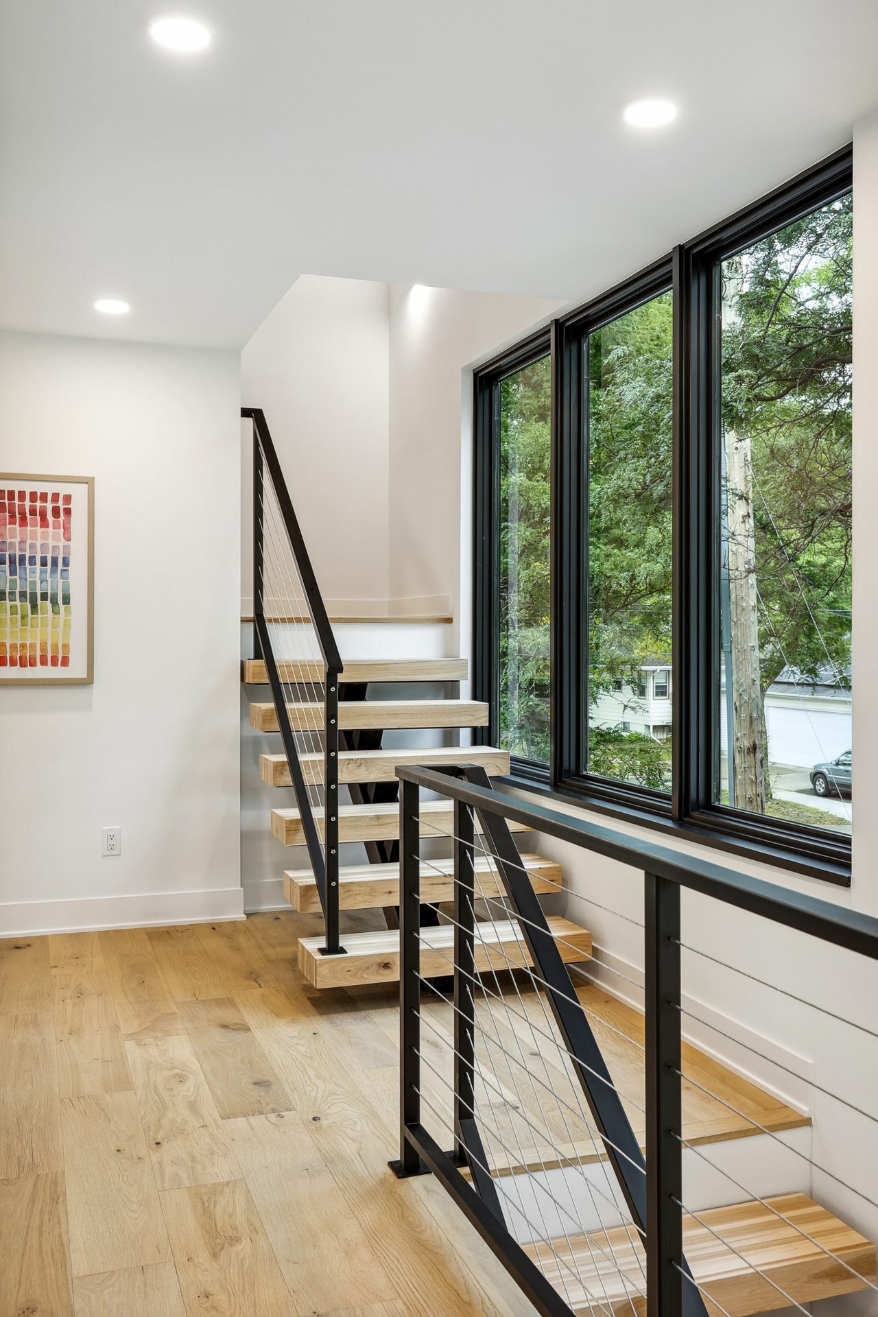Floating steel staircase leading to the second level