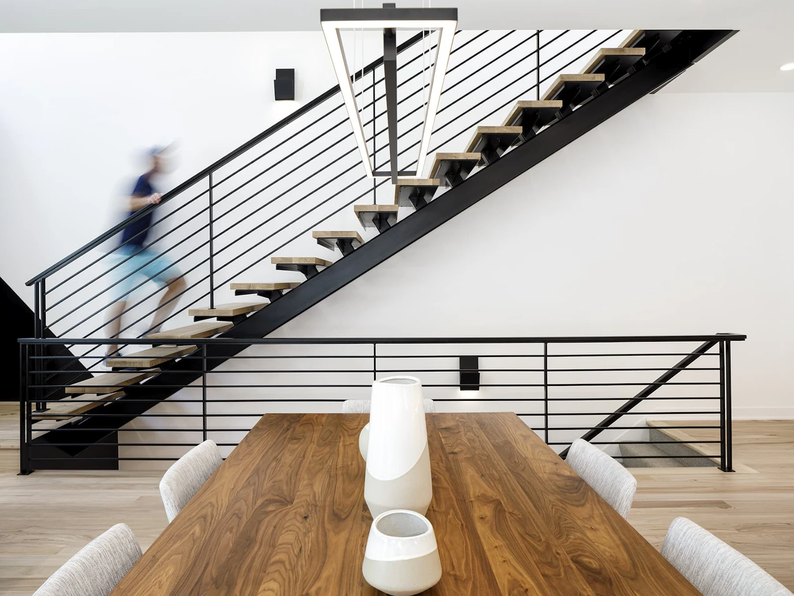 Floating steel staircase with white oak stair treads