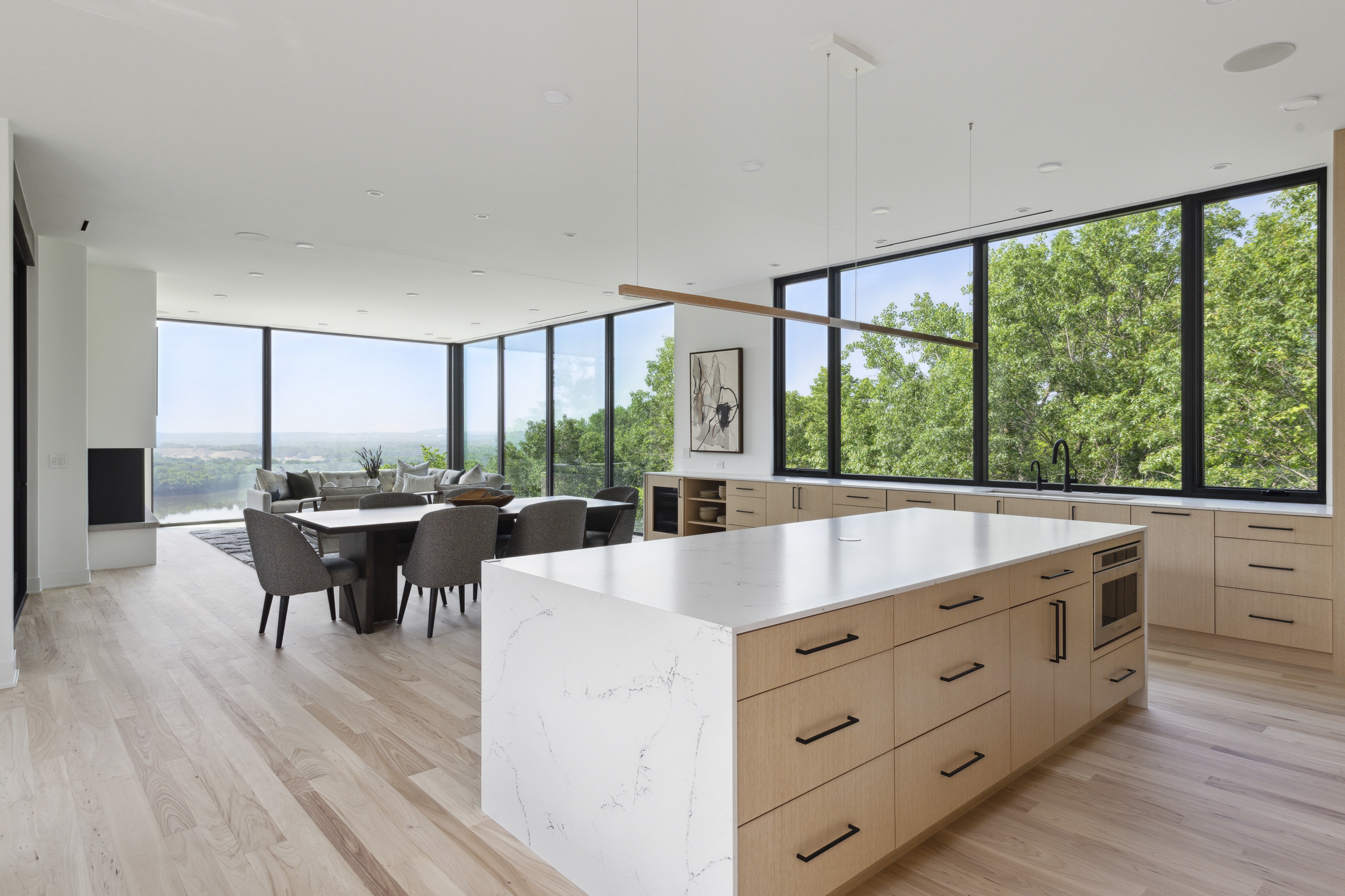 Open kitchen, dining, and living room with views all around