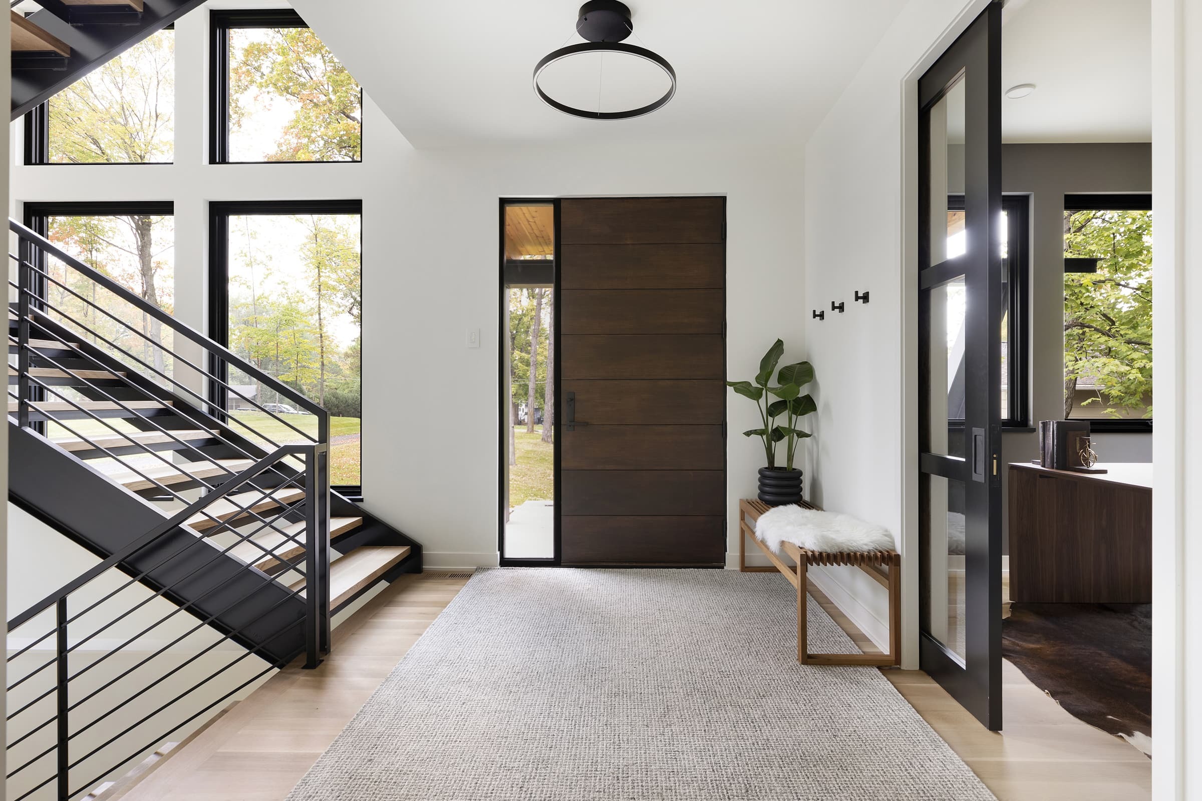 Entryway with large floating steel staircase