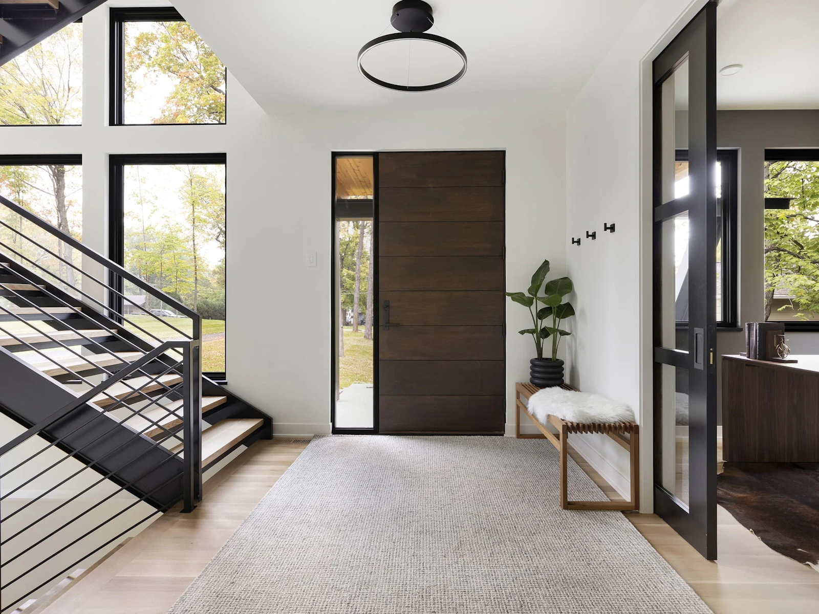 Entryway with large floating steel staircase